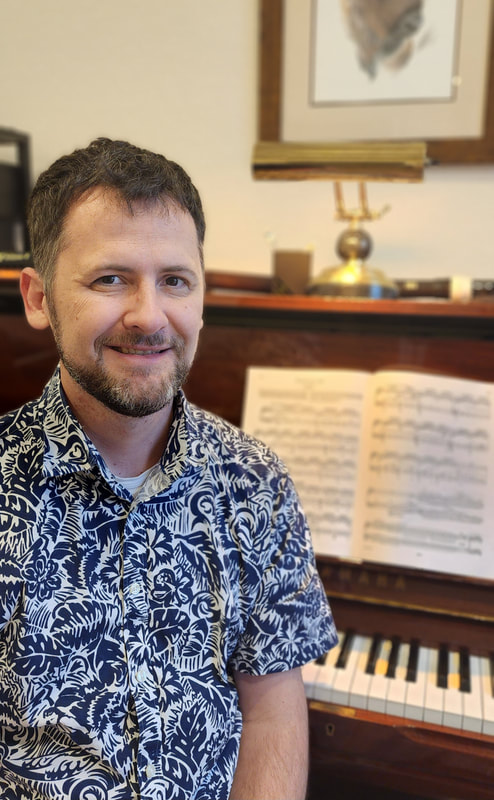 smiling piano teacher in Hawaiian shirt