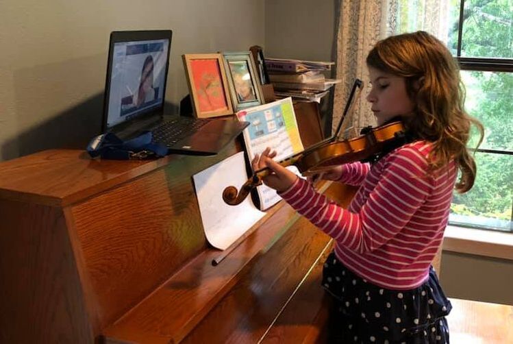 Music student playing violin online