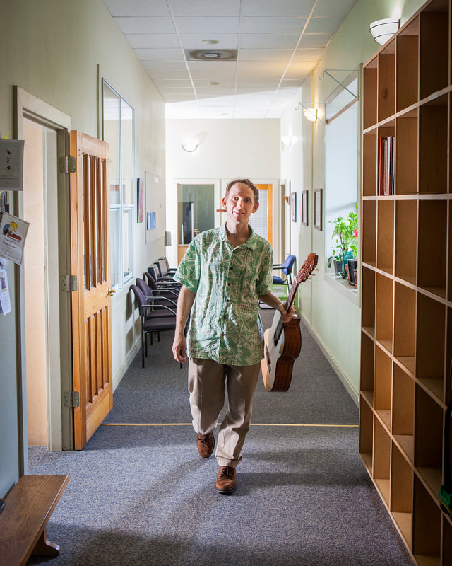 Klondike Steadman holding a guitar in hallway